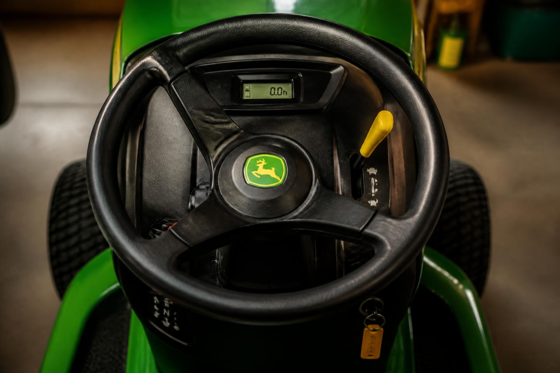 John Deere tractor on open farmland at golden hour